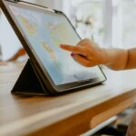 Child pointing at a map on a tablet