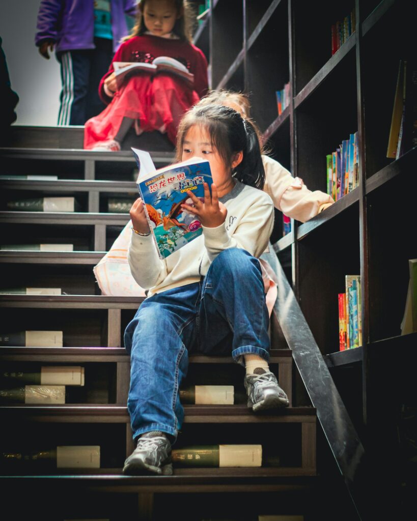 Young girl reading a book in a library